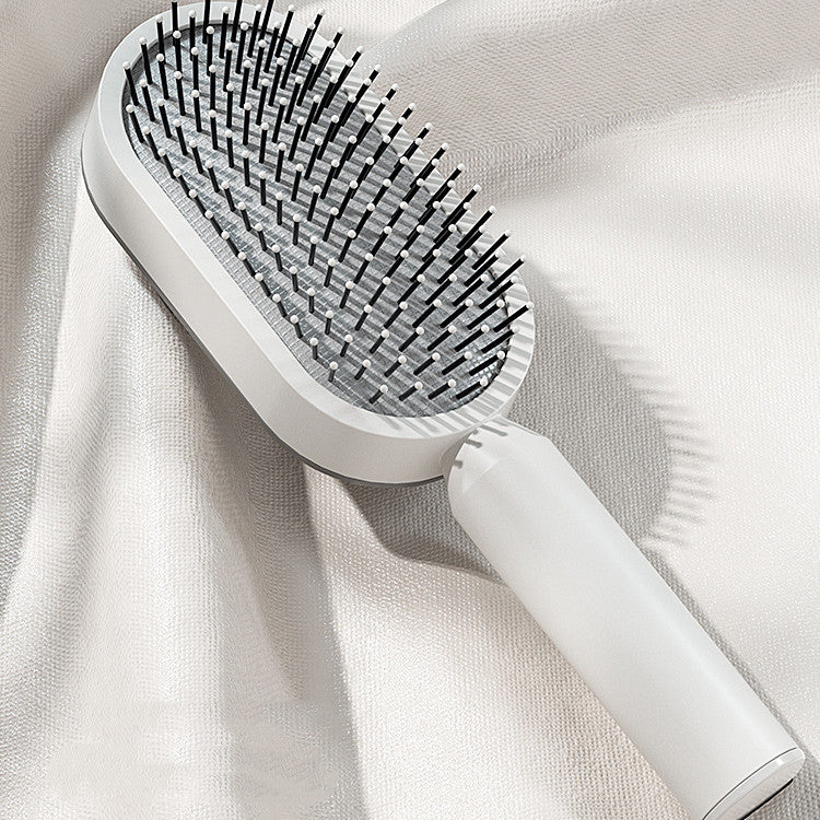 Women's self-cleaning hair brush