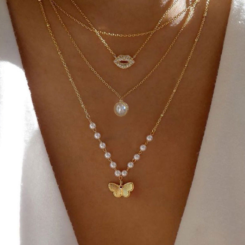 Crafted with multilayer gold-plated chains and detailed with pearl butterflies and a sun star pendant, this necklace makes a charming and timeless gift.