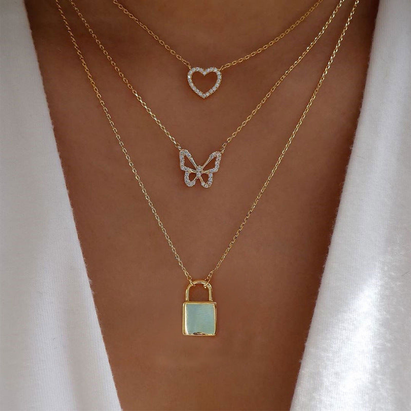 Crafted with multilayer gold-plated chains and detailed with pearl butterflies and a sun star pendant, this necklace makes a charming and timeless gift.