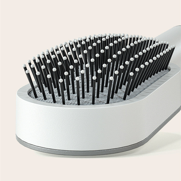 Women's self-cleaning hair brush